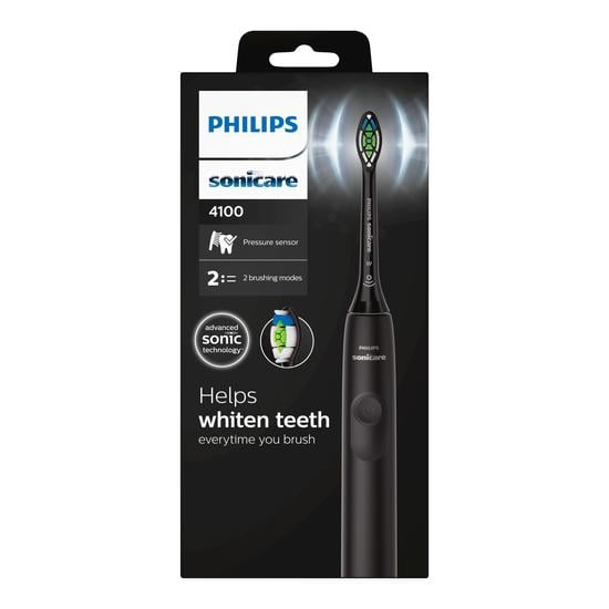 Black Philips Sonicare 4100 electric toothbrush in retail packaging with pressure sensor and sonic technology features.