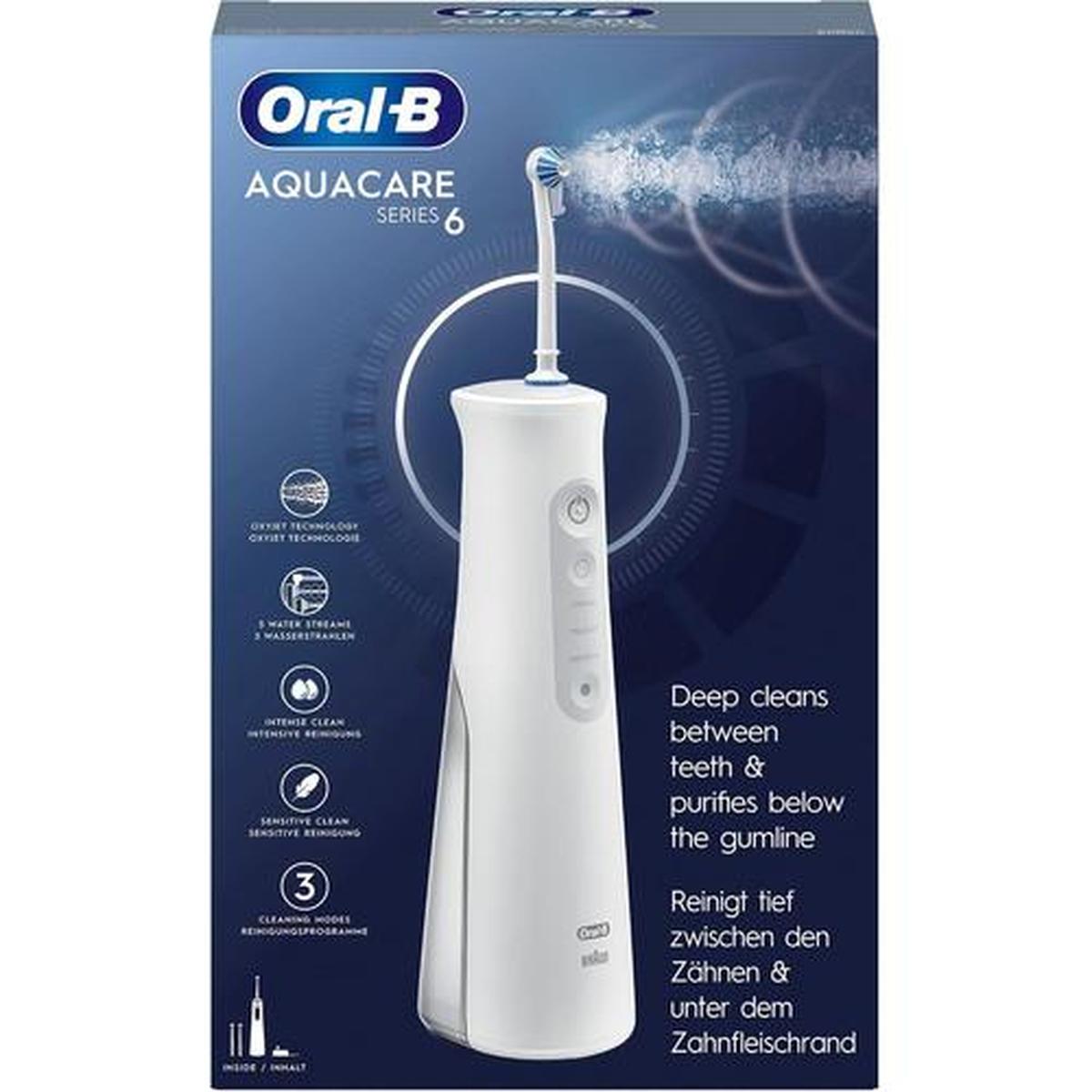 White Oral-B Aquacare cordless dental irrigator with Oxyjet nozzle shown on product packaging with feature icons.