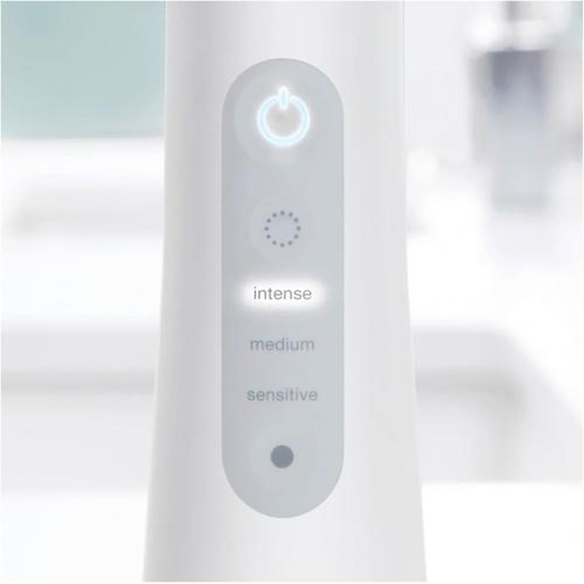 White Oral-B Aquacare control panel with illuminated power button and intense, medium, and sensitive intensity settings.