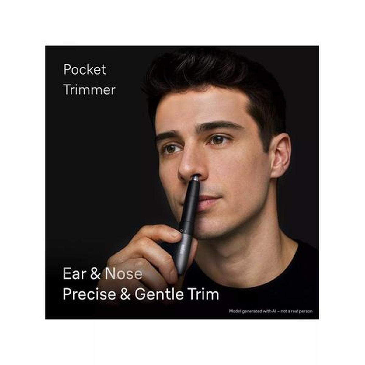 Man using a compact black Braun EN20 ear and nose trimmer for precise, gentle hair removal against a dark background.