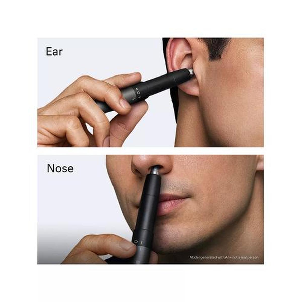 Compact black Braun EN20 ear and nose trimmer being used to gently remove hair with its precise dual-blade head.