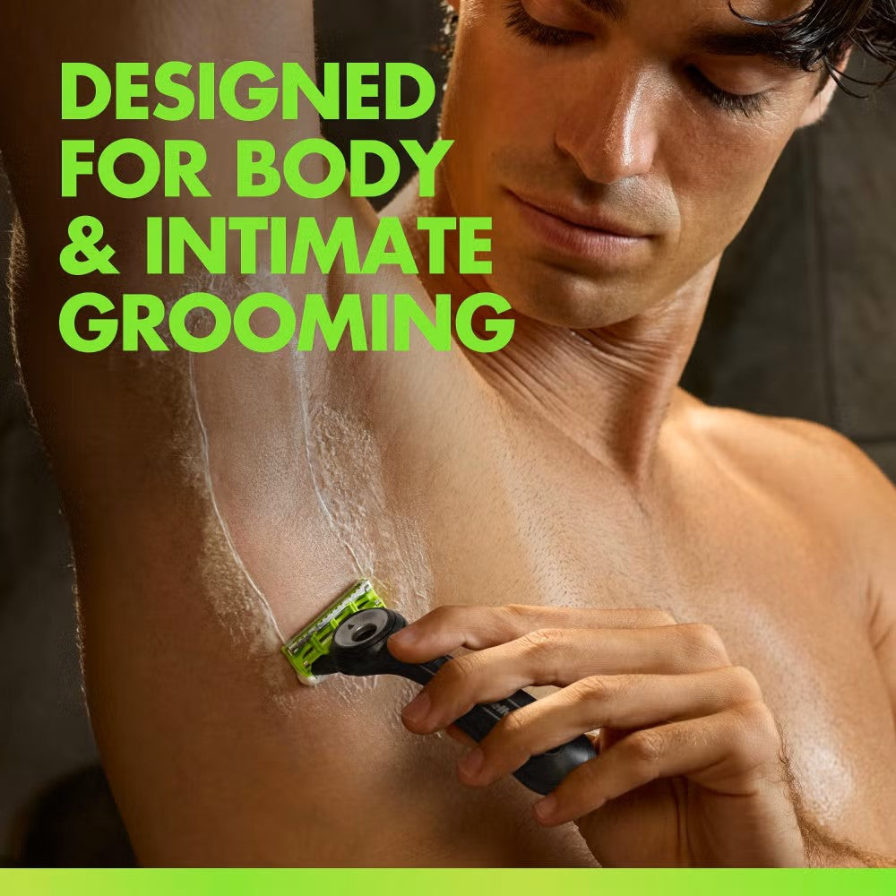 Man using a black and lime green Gillette Labs body razor to shave his underarm with shaving gel.