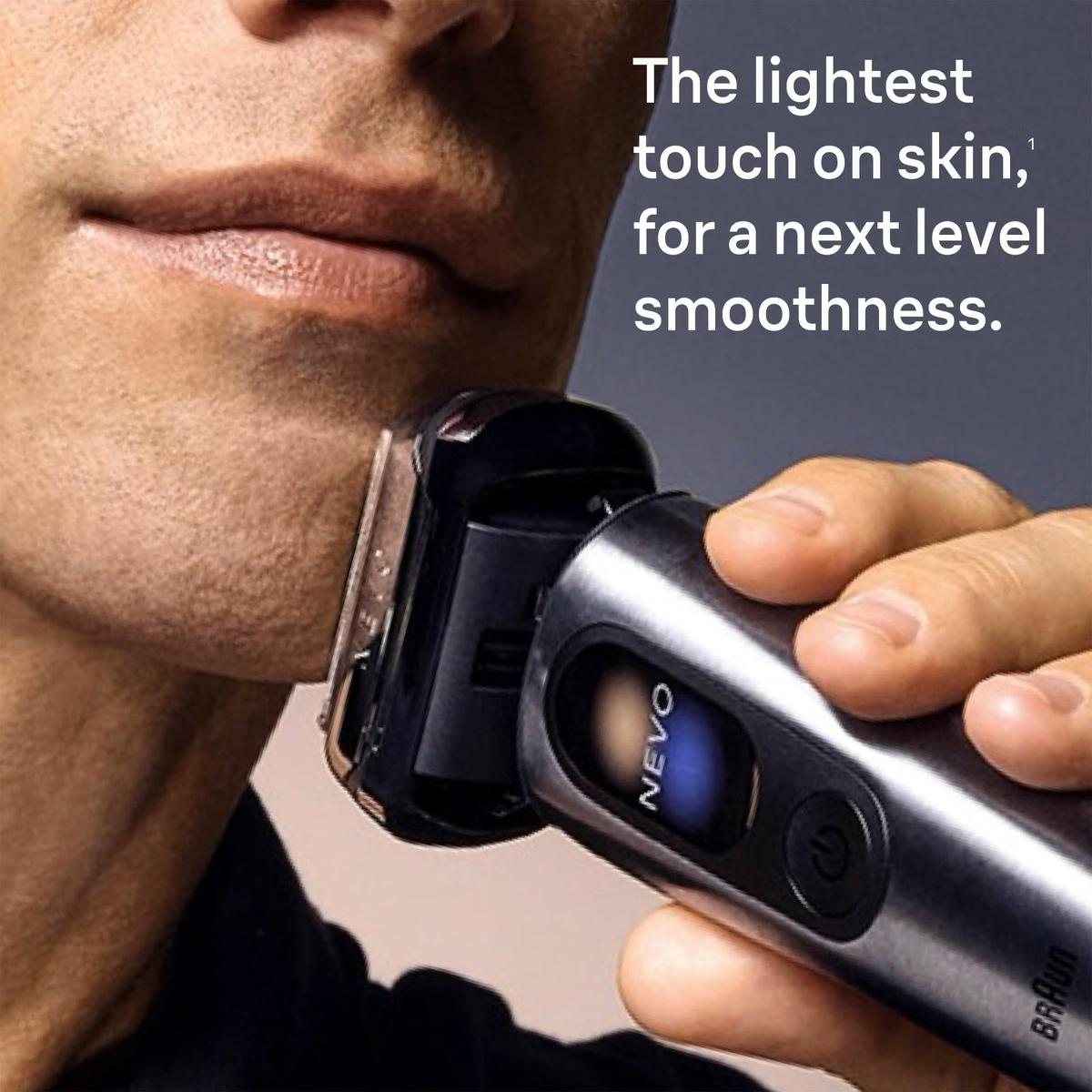 Graphite Braun Nevo electric shaver with stainless steel body and digital display being used for a close shave.