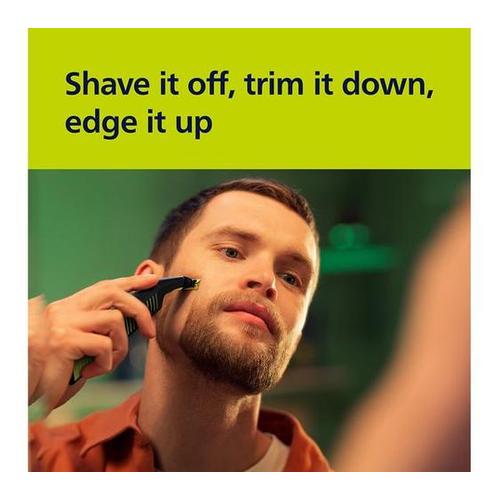 Man using a black Philips OneBlade Pro to trim and edge his beard in a mirror, with text overlay above.