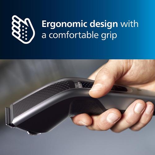 Hand holding a sleek, black Philips Series 5000 hair clipper featuring an ergonomic design and textured grip.
